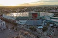 aerial shot of the Los Angeles Convention Center at sunset with cars driving on the freeway, office buildings in the city skyline