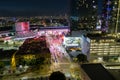 aerial shot of the Los Angeles Convention Center at sunset with cars driving on the freeway, office buildings in the city skyline