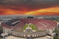 aerial shot of the Los Angeles Memorial Coliseum at Exposition Park with green trees and grass and office buildings and apartments