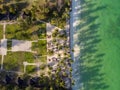 Aerial shot of a luxury hotel on a Beach first line with Palm Trees Drops their Shades on a High Tide Water of Indian