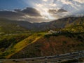 An aerial shot of the majestic mountain ranges with homes along the coastline of California, freeways with cars and powerful cloud