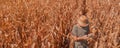 Aerial shot of male agronomist and farmer using drone remote controller to examine plantation Royalty Free Stock Photo