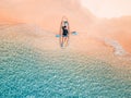 Aerial shot of man relaxing in a kayak Summer seascape beach and blue sea water Top view from drone