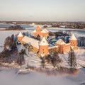 Aerial shot of the medieval Trakai Island Castle on a snowy winter day surrounded by the frozen lake Royalty Free Stock Photo