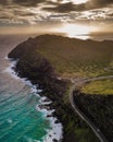 Aerial shot of mesmerizing Oahu island coastline with sun rays shining on the sea in the background