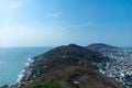 Aerial shot of a mountain coast bordering the city of Vung Tau in Vietnam under a blue sky Royalty Free Stock Photo