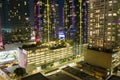 aerial shot of the Moxy Downtown Los Angeles and the Chase building with rooftop pools, lush green trees in front of Crypto Arena