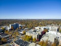 An aerial shot of the office buildings, apartments, red and yellow autumn trees, lush green trees, in the city skyline Royalty Free Stock Photo