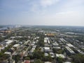 Aerial shot of the office buildings, apartments and shops in the city skyline surrounded by a river, lush green trees, roads and