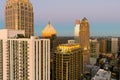 aerial shot of office buildings, skyscrapers in the city skyline at sunset with cars driving on the freeway in Atlanta Georgia