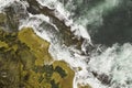 Aerial shot of rock ledge and crashing waves Royalty Free Stock Photo