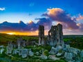 Aerial shot of an old ruins of Corfe Castle, Dorset during sunset Royalty Free Stock Photo