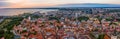 Aerial shot of the old town of Tallinn with orange roofs, churches' spires and narrow streets