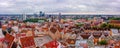 Aerial shot of the old town of Tallinn with orange roofs, churches' spires and narrow streets