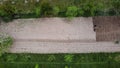 Aerial shot of a piece of agricultural land and a man cultivating it