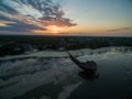 Aerial shot of a pier on the beach by the ocean captured under the sunset in Zanzibar, Africa Royalty Free Stock Photo