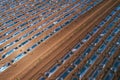 Aerial shot of plastic sheeting tunnel hothouse equipment on watermelon plantation from drone pov