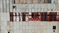 AERIAL SHOT Post Apocalyptic background from ferroconcrete wall Row of panels with rusty spots With around hat on the