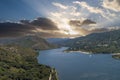 aerial shot of the rippling blue waters of Silverwood Lake with a beach, mountains covered in lush green trees, plants and grass Royalty Free Stock Photo