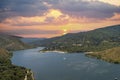 aerial shot of the rippling blue waters of Silverwood Lake with a beach, mountains covered in lush green trees, plants and grass Royalty Free Stock Photo