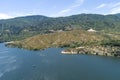 aerial shot of the rippling blue waters of Silverwood Lake with a beach, mountains covered in lush green trees, plants and grass Royalty Free Stock Photo