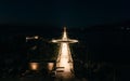 An aerial shot of a road illuminated by street lights