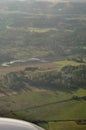 Aerial shot of rural countryside with green forest areas, crop fields, roads and farms. Beautiful nature captured from an airplane Royalty Free Stock Photo