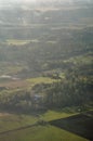 Aerial shot of rural countryside with green forest areas, crop fields, roads and farms. Beautiful nature captured from an airplane Royalty Free Stock Photo