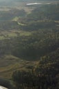 Aerial shot of rural countryside with green forest areas, crop fields, roads and farms. Beautiful nature captured from an airplane Royalty Free Stock Photo