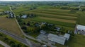 Aerial Shot Of A Rural Intersection With Railroad Tracks, Farms With Silos, Patchwork Fields Royalty Free Stock Photo