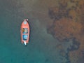 Aerial shot of sailboat on the ocean with beautiful view of coral reefs underwater