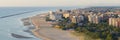 Aerial shot of sandy beach with parasol and on right Lido Adriano town