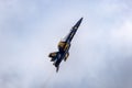 Aerial shot of a single Blue Angels aircraft in the air against the clouds Royalty Free Stock Photo
