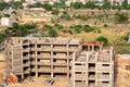 Aerial shot of the skeleton of an under construction school multi story building in developing countryside