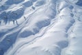 aerial shot of ski tracks on a snowy mountain slope Royalty Free Stock Photo