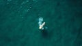 Aerial shot of a small boat alone in the turquoise water Royalty Free Stock Photo