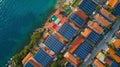 An aerial shot of a small coastal town lined with colorful houses accentuated by the use of solar panels on each rooftop