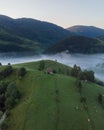 Aerial shot of a small house in an amazing mountain landscape in Transylvania, Romania