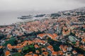 Aerial shot of small houses with orange rooftops by the Atlantic ocean in the Madeira island Royalty Free Stock Photo