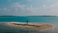 Aerial shot of the small isolated amazing beautiful tropical island with beach in lagoon at the middle of indian ocean Royalty Free Stock Photo