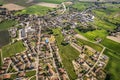 Aerial shot of a small town in a picturesque landscape of lush green fields in the countryside