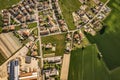 Aerial shot of a small town in a picturesque landscape of lush green fields in the countryside Royalty Free Stock Photo