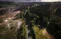 Aerial shot of a smooth road in the forest Royalty Free Stock Photo