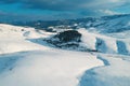 Aerial shot of snow-capped hill top lit by the setting sun in winter sunset at Zlatibor Royalty Free Stock Photo