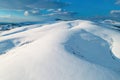 Aerial shot of snow-capped hill top lit by the setting sun in winter sunset at Zlatibor, Serbia Royalty Free Stock Photo