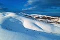 Aerial shot of snow-capped hill top lit by the setting sun in winter sunset at Zlatibor Royalty Free Stock Photo