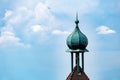 Aerial shot of a spire of a building against a blue sky in Freiburg im Breisgau city in Germany. Royalty Free Stock Photo