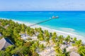 Aerial shot of the Stilt hut with palm thatch roof washed with turquoise Indian ocean waves on the white sand sandbank beach on Royalty Free Stock Photo