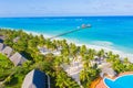 Aerial shot of the Stilt hut with palm thatch roof washed with turquoise Indian ocean waves on the white sand sandbank beach on Royalty Free Stock Photo