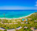 Aerial shot of the Stilt hut with palm thatch roof washed with turquoise Indian ocean waves on the white sand sandbank beach on Royalty Free Stock Photo